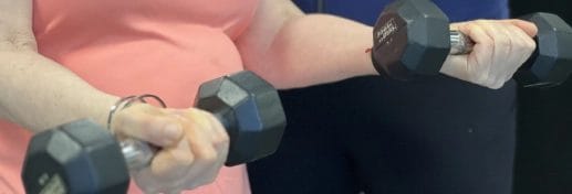 woman hold two weights